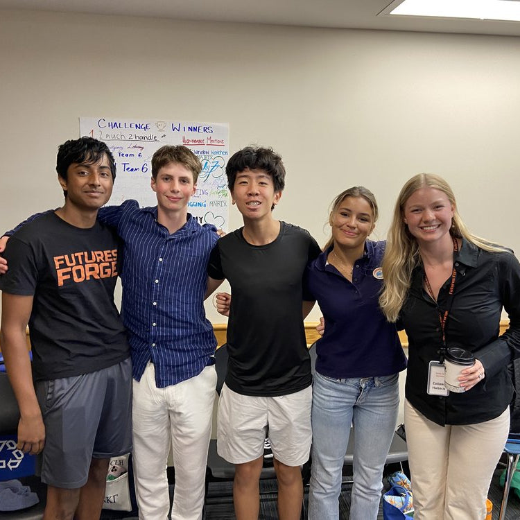 Five high school students celebrating teamwork in a summer program focused on skills for success in college and careers.