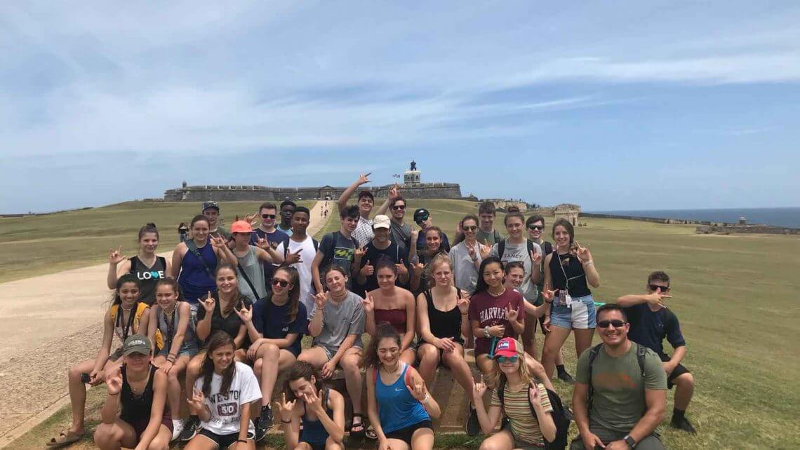 Group of teens participating in a summer program for hurricane relief in Puerto Rico, showcasing teamwork and community spirit.