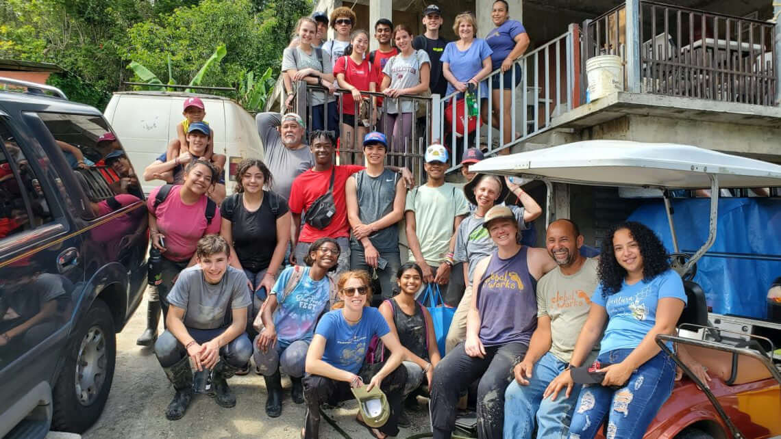 Group of teens and adults participating in a hurricane relief service trip in Puerto Rico during summer program.