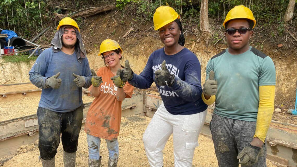 Teens participating in a hands-on hurricane relief service trip in Puerto Rico, showing teamwork and enthusiasm.