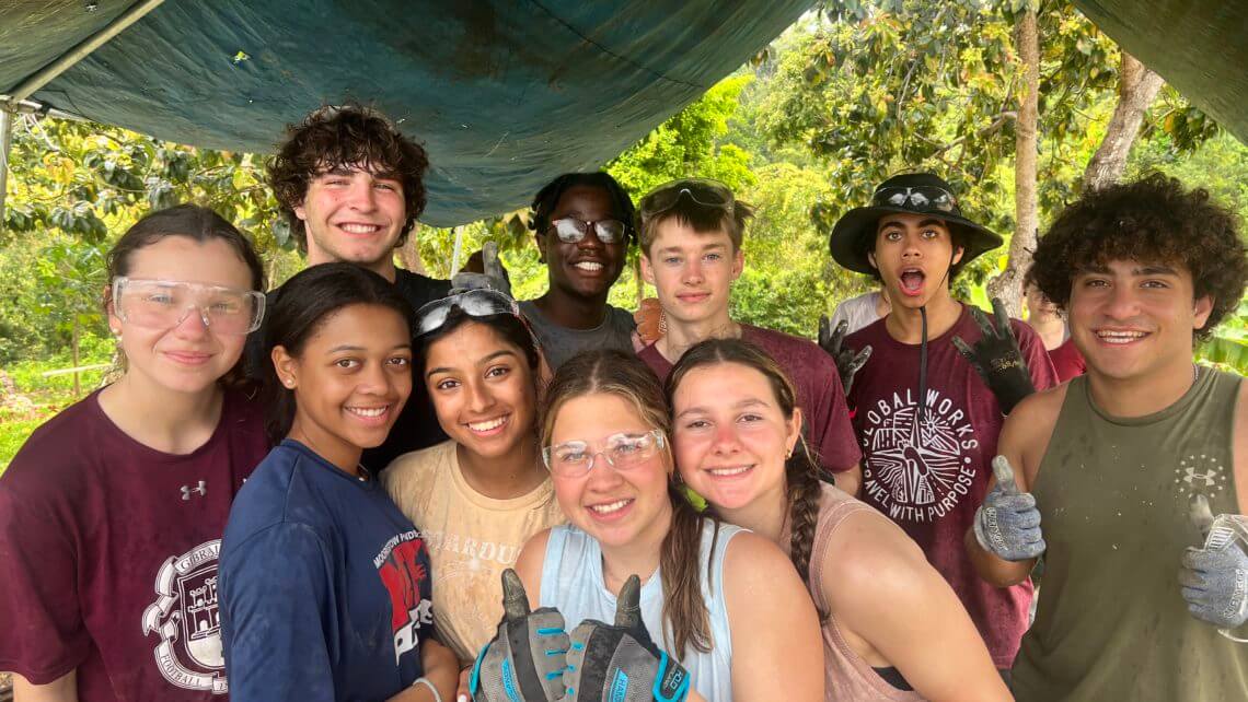 Group of teens smiling together during a summer hurricane relief service trip in Puerto Rico.