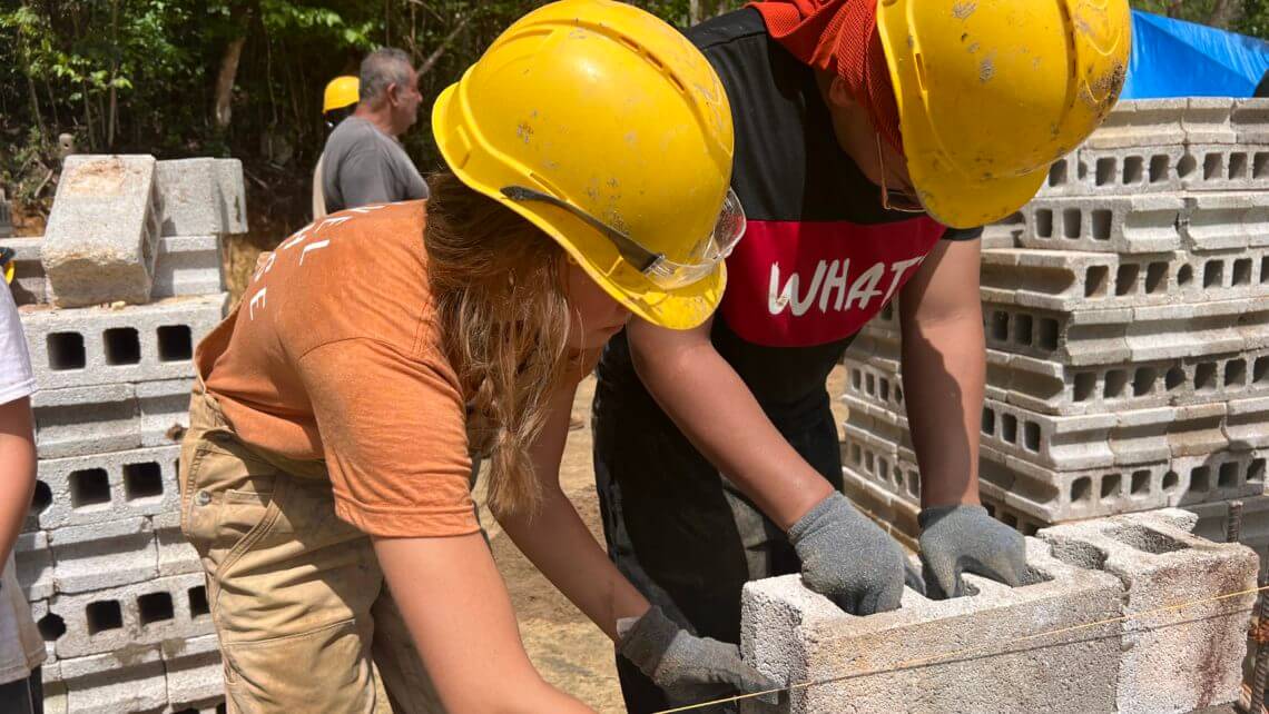 Teens participating in a hands-on summer program building hurricane relief infrastructure in Puerto Rico.