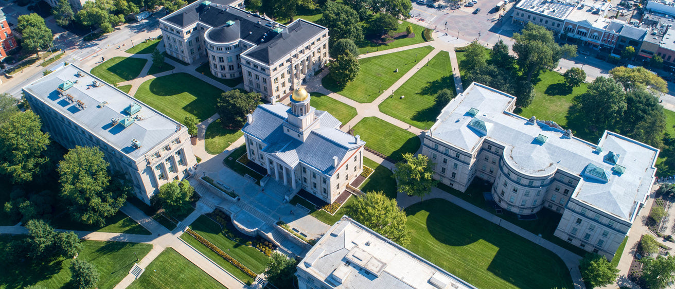 Aerial view of a college campus featuring landscaped grounds and historic buildings, ideal for summer programs and high school activities.