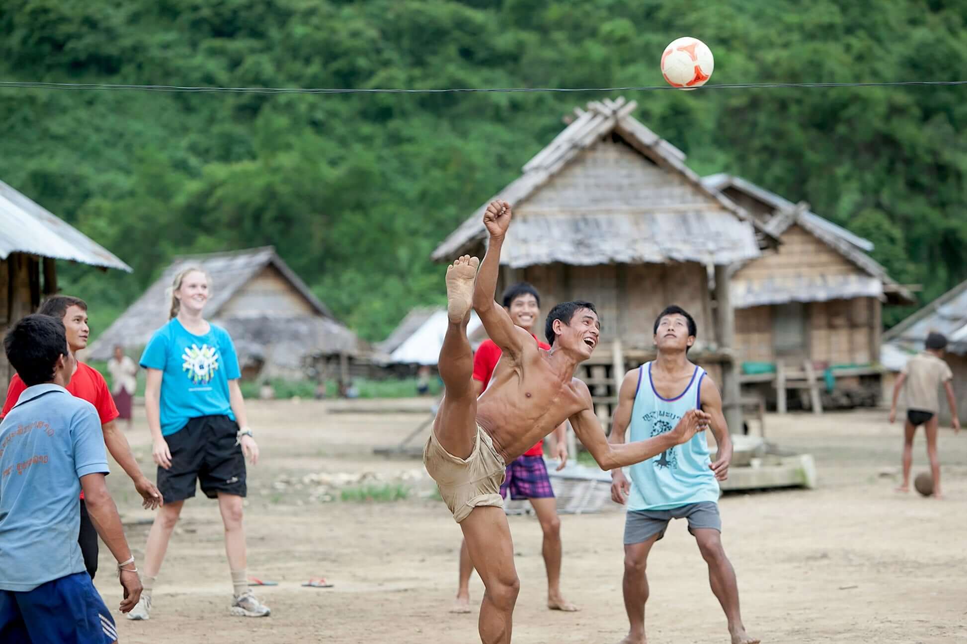 Teenagers playing soccer in a remote Thai village during a summer expedition in the Mekong region.