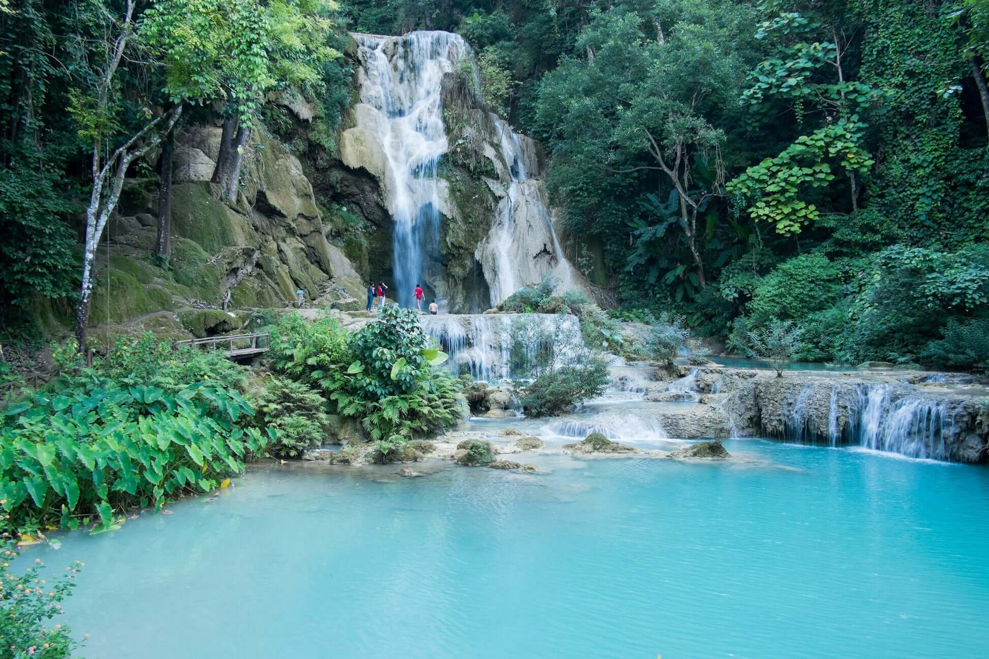 Scenic waterfall surrounded by lush greenery in Northern Thailand, ideal for a high school summer expedition.