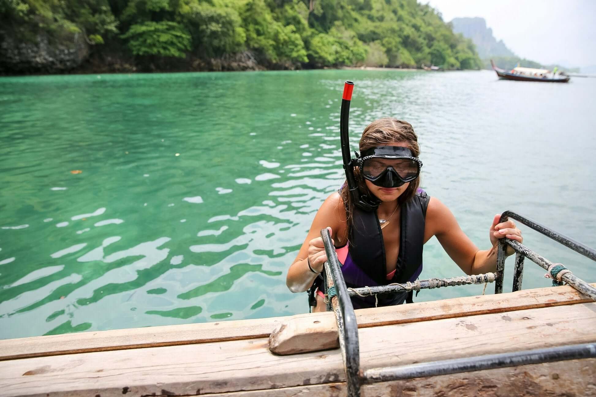 High school student exploring northern Thailand, snorkeling in clear blue waters and enjoying an adventurous student travel experience.