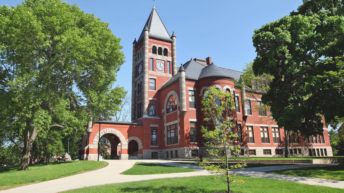 Historic academic building surrounded by lush greenery, perfect for summer camps and programs for middle and high school students.
