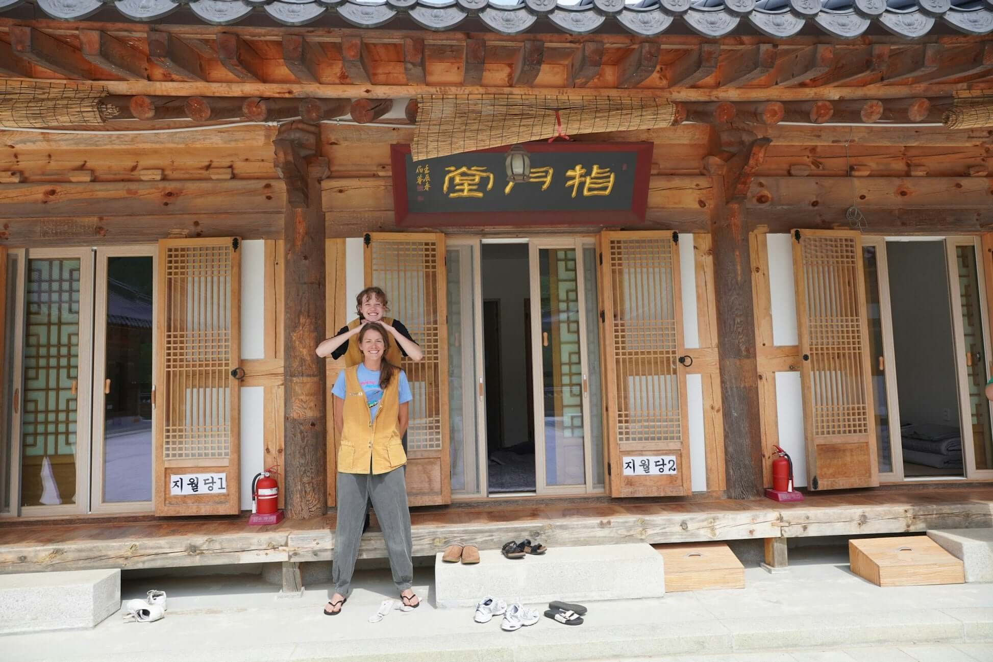 Teen travelers enjoying traditional South Korean culture in a hanok-style home during a summer program.