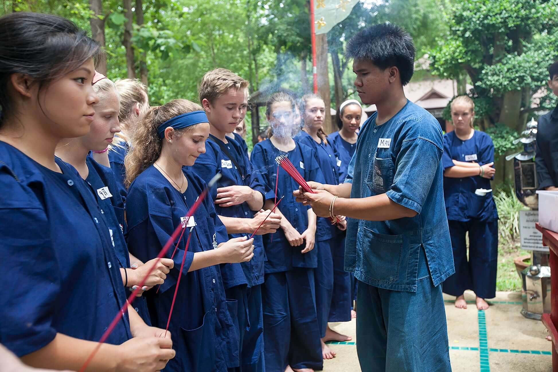 High school teens participating in a Thai elephant conservation ritual, bonding and learning as junior mahouts.
