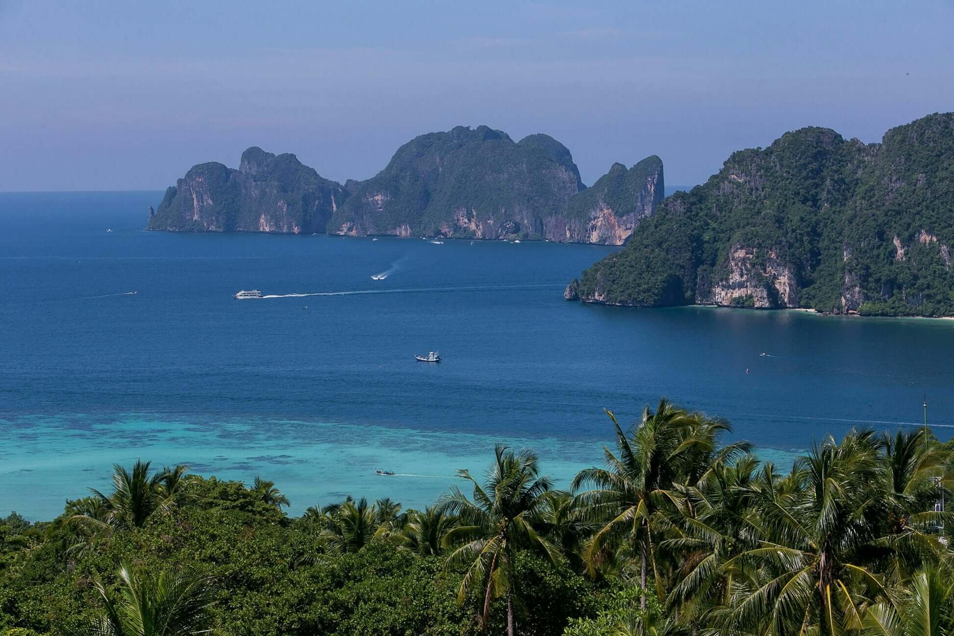 Breathtaking view of southern Thailand's limestone cliffs and turquoise waters, perfect for high school student travel adventures.