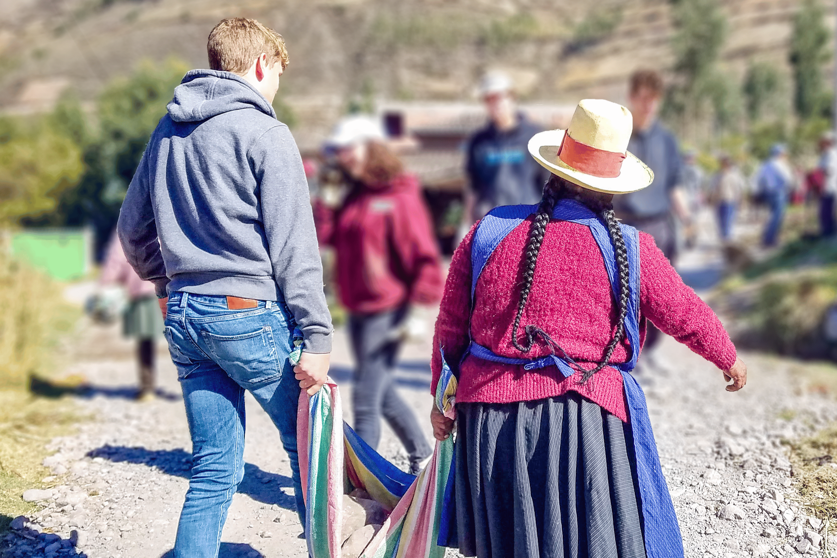 Teen participant engaging with indigenous Quechua people during a summer program in Peru's Sacred Valley.