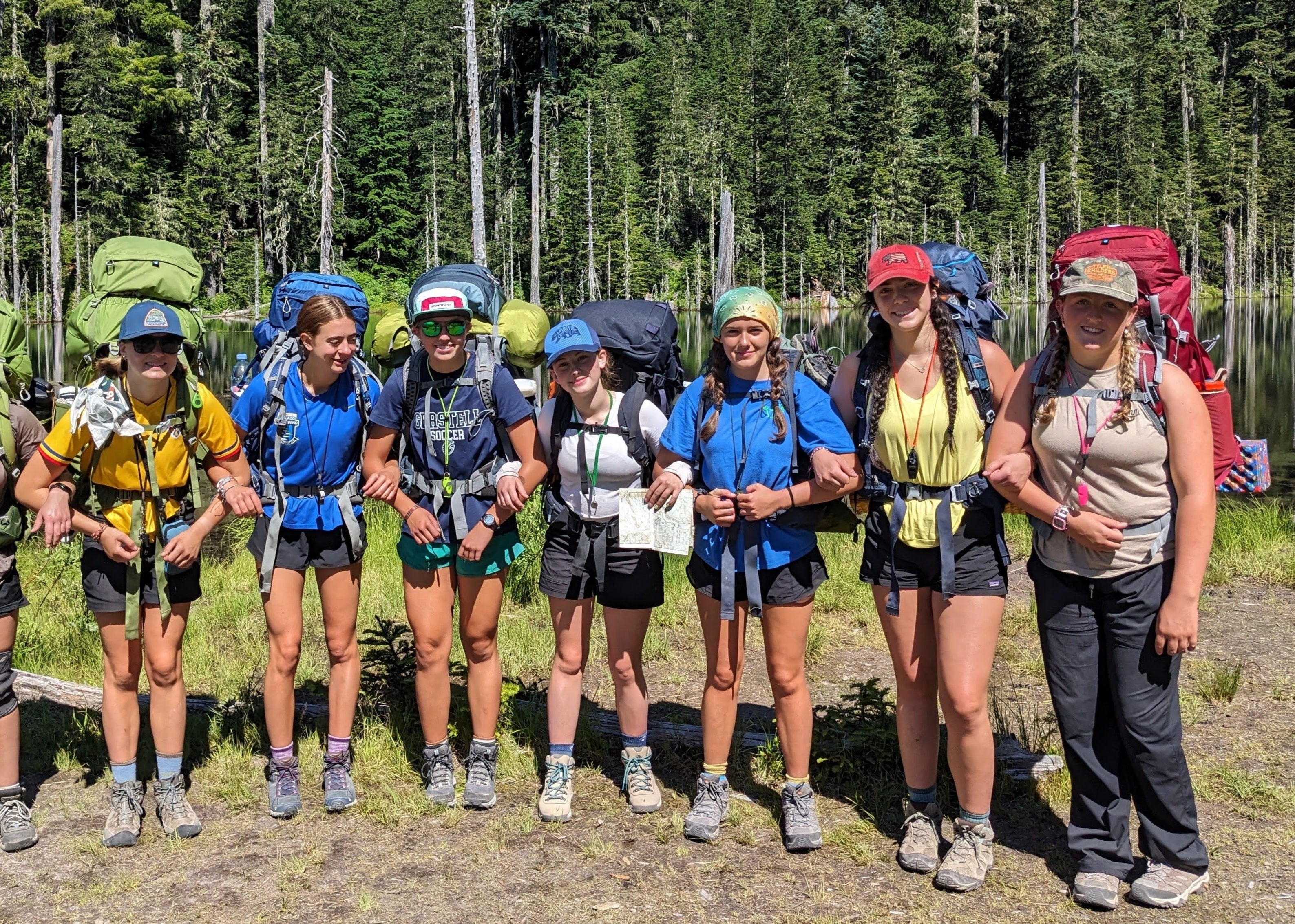 Group of teens ready for adventure at Alpengirl Camp, backpacking in the Pacific Northwest wilderness.