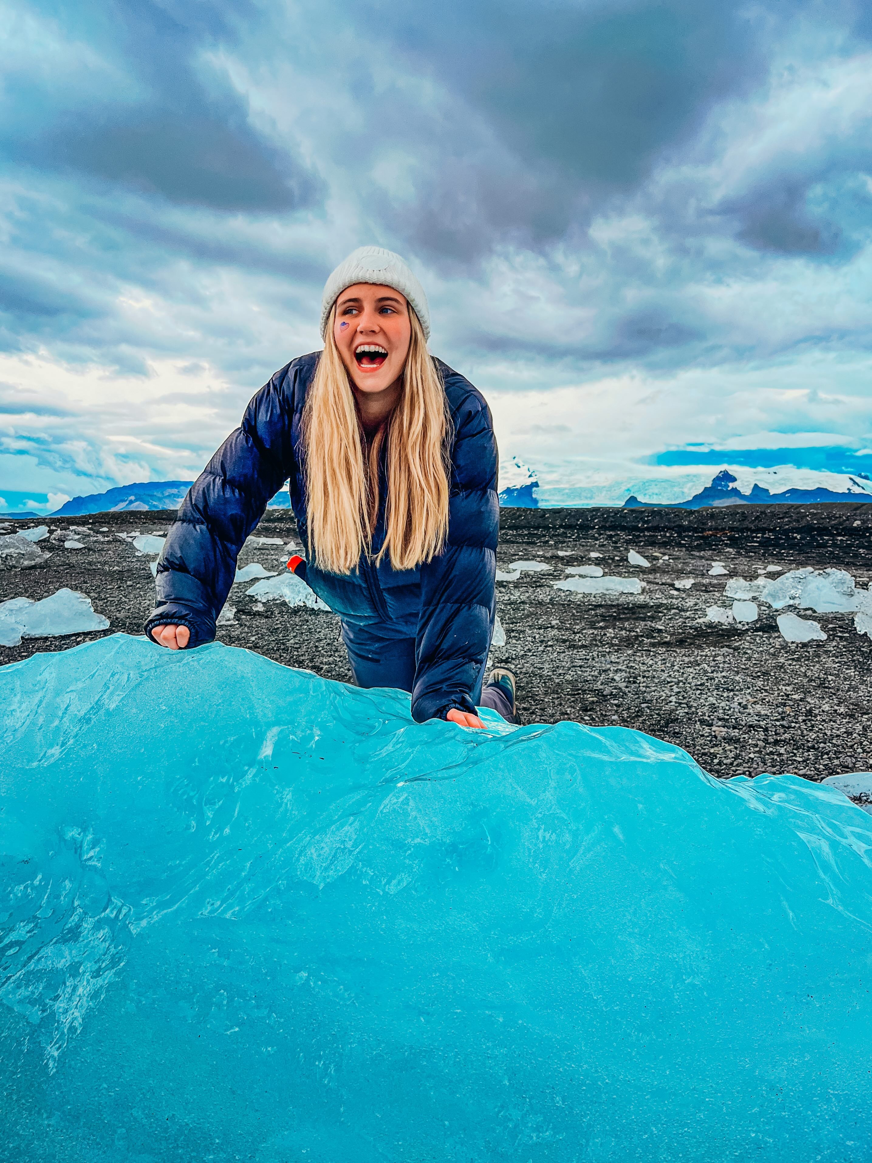 Young woman enjoying Iceland's glaciers, highlighting teen travel experiences in summer programs.