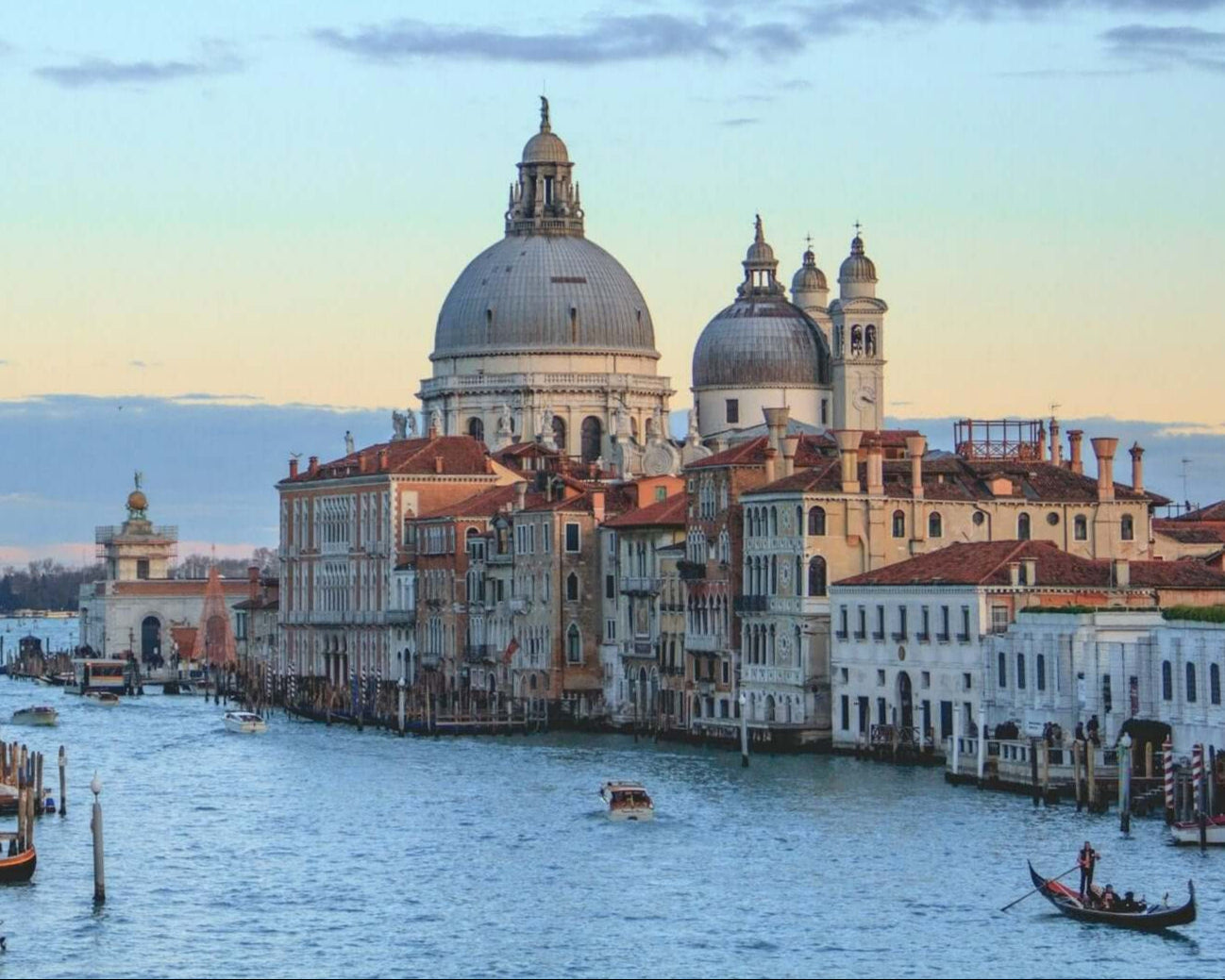 Scenic view of Venice with grand domes and a tranquil canal, perfect for student travel adventures in Northern Italy.