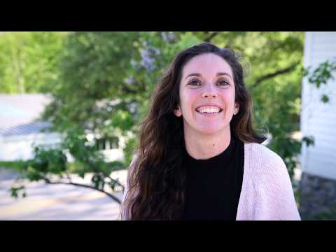 Smiling woman outdoors, promoting summer programs and experiential education for students.