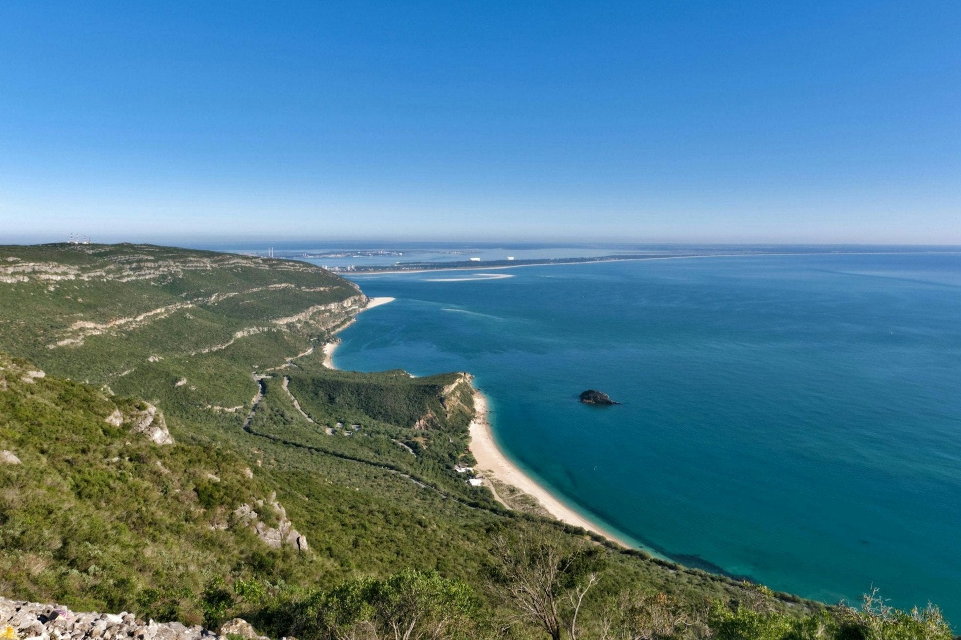 Scenic view of the rugged coastline and turquoise waters near Lisbon, showcasing Portugal's natural beauty.