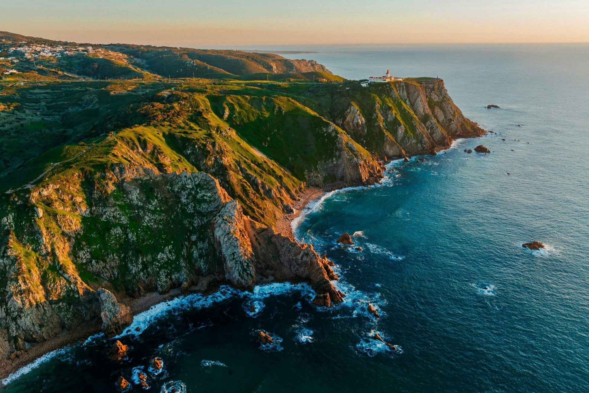 Scenic coastal cliffs of Portugal at sunset, showcasing the beauty of Lisbon's summer surf culture.
