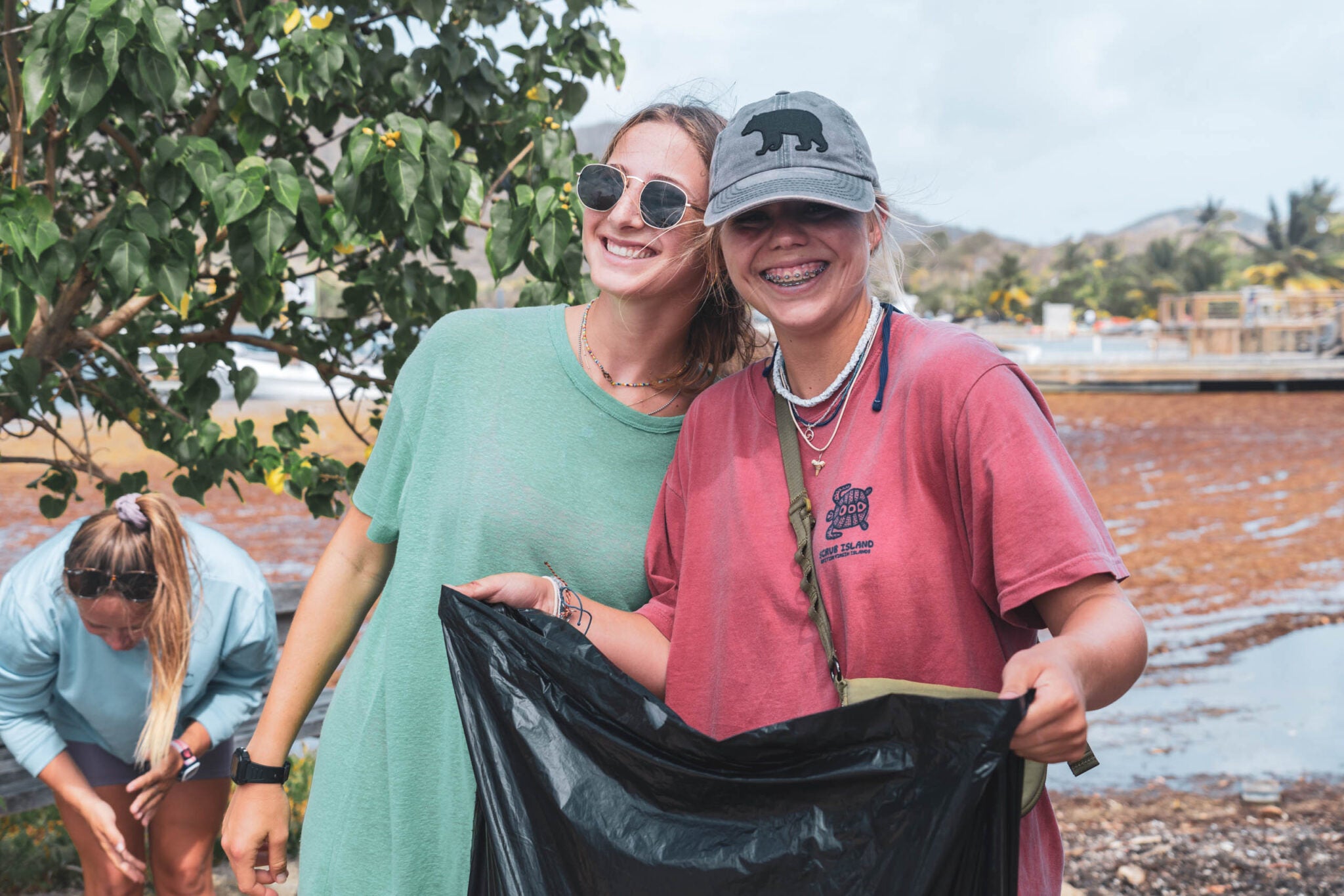 High school students participating in beach clean-up during summer programs in the Caribbean.