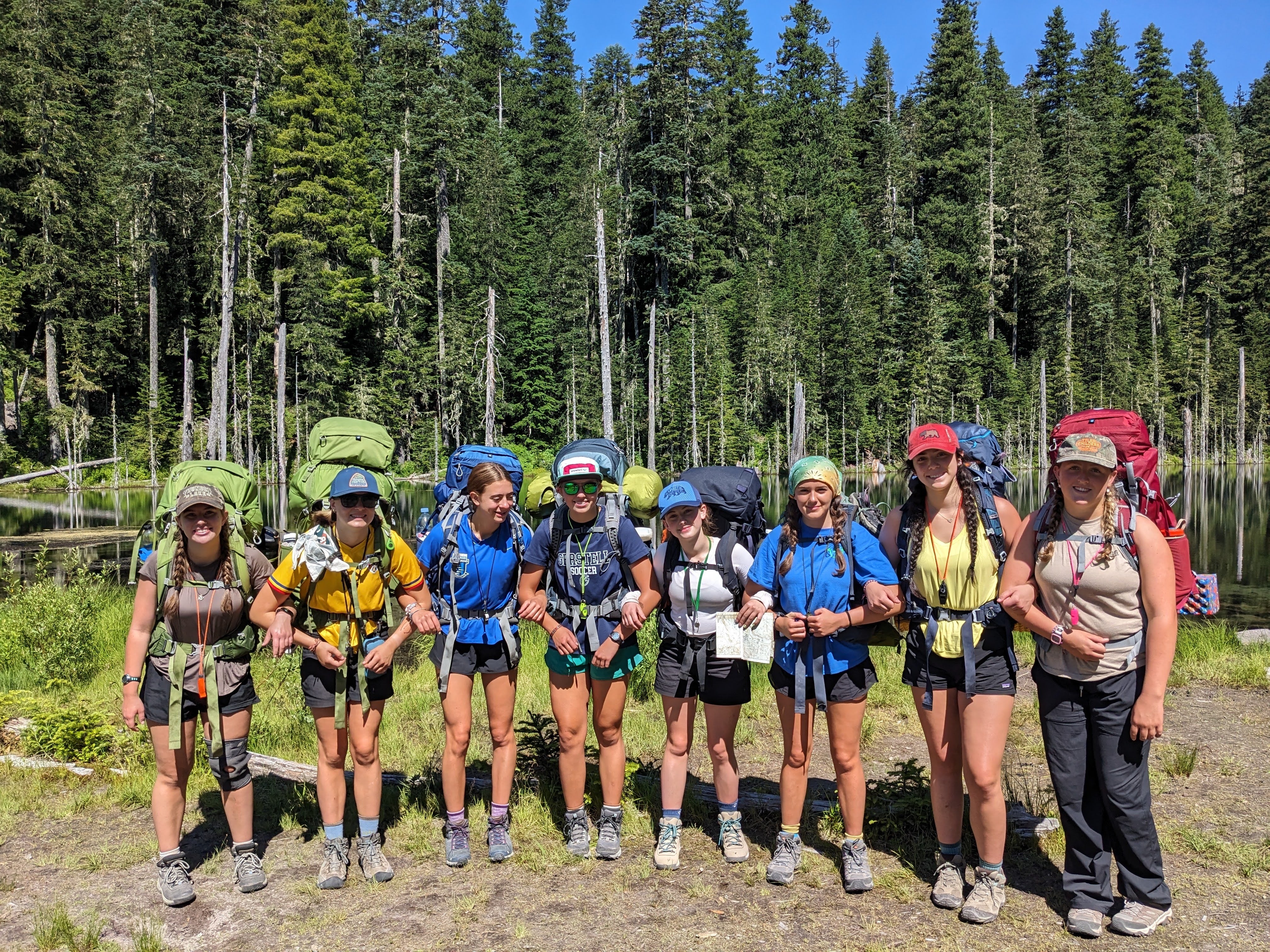Group of teens ready for adventure at Alpengirl Camp, backpacking in the Pacific Northwest wilderness.